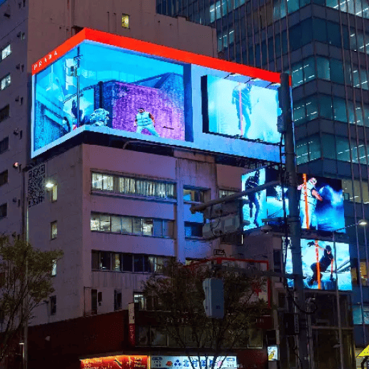 Illuminated 3D billboards showcasing the Prada Linea Rossa Fall/Winter 2022 campaign in a vibrant urban night setting.