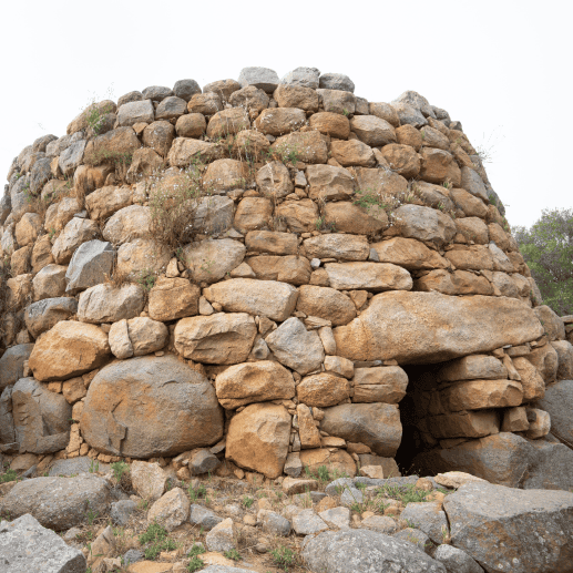 An ancient stone nuraghe in Sardinia, showcasing its characteristic circular structure.